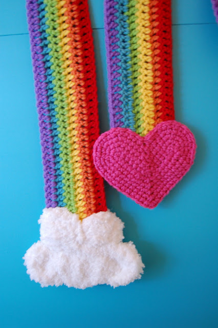 a rainbow coloured scarf with a heart on one end and a cloud on the other