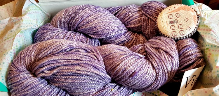 box of purple coloured yarn