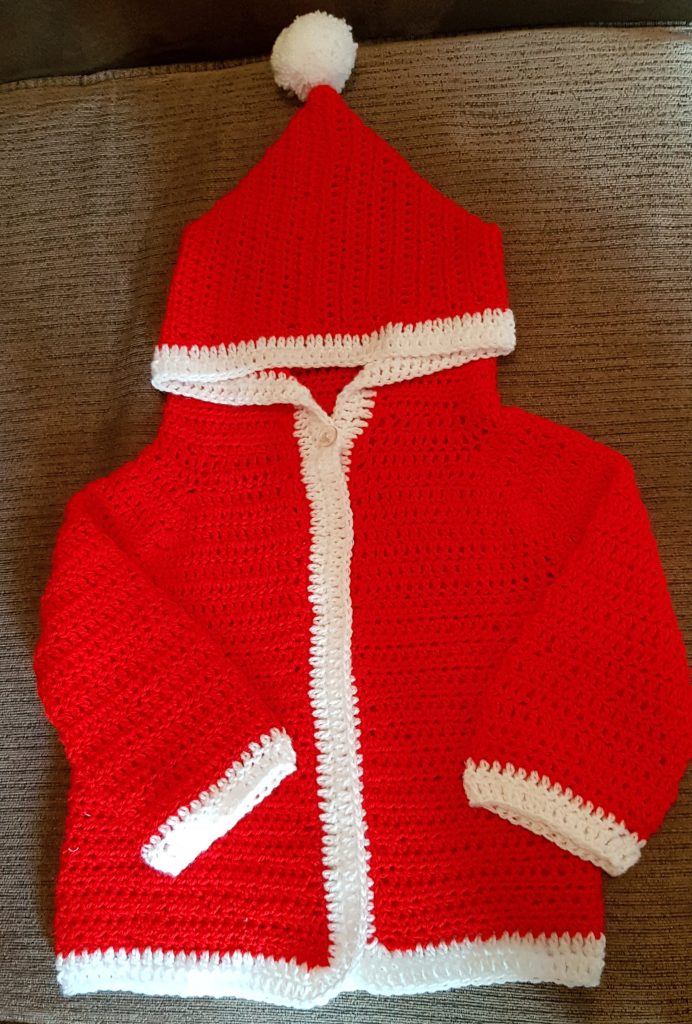 crochet red and white santa jacket for a baby.