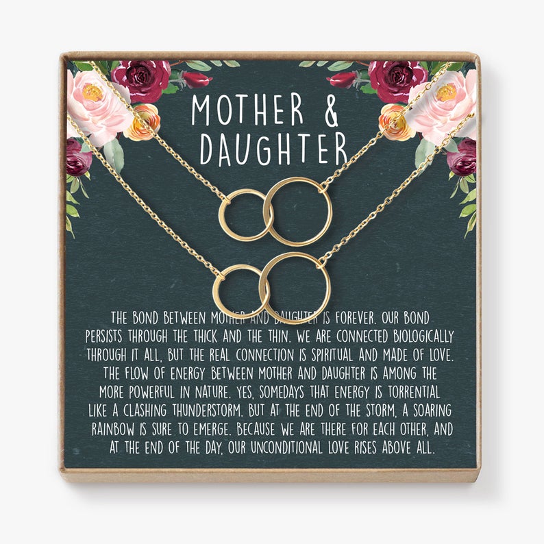 twin necklaces for mother and daughter on flower background card.