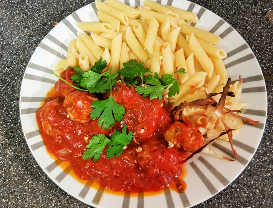 mindful eating, image shows pork meatballs in a rich tomato sauce