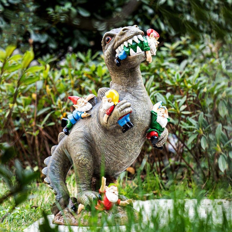 T rex dinosaur garden ornament, attacking garden gnomes. 