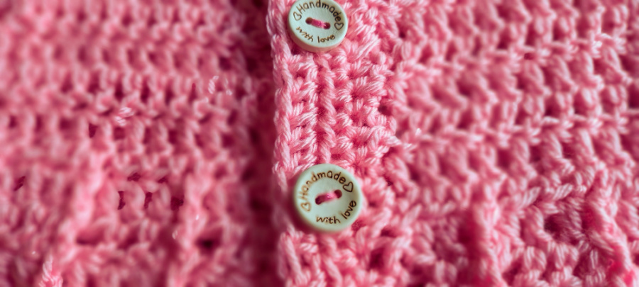 close up of baby cardigan showing cute buttons