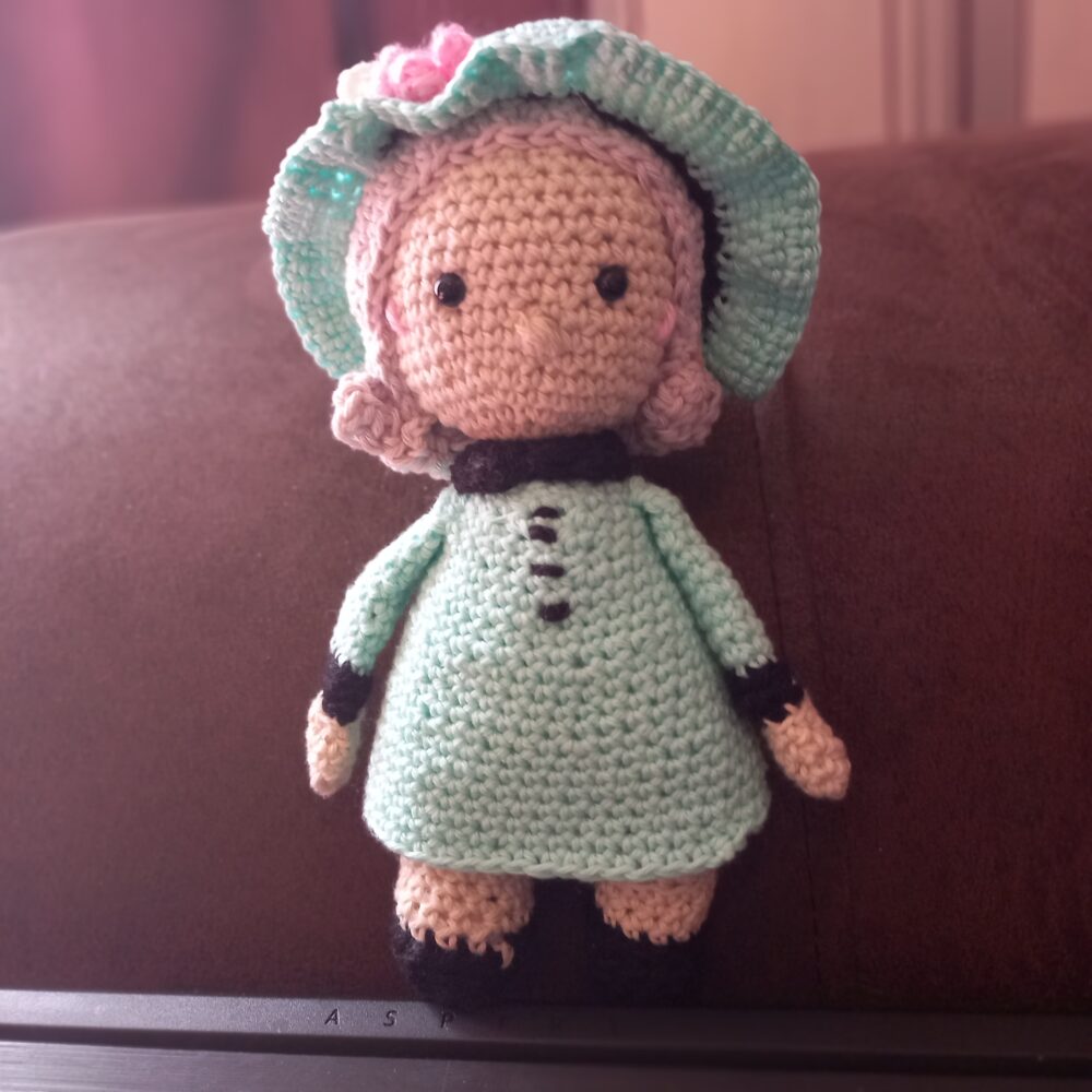 amigurumi crochet toy of Queen Elizabeth in turquoise dress
