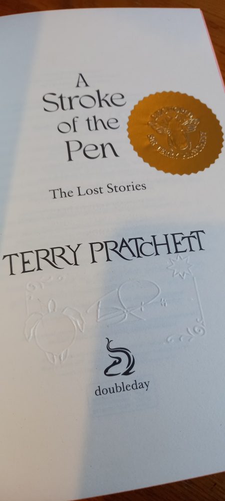 A Stroke of the Pen inside the cover with gold embossed sticker and embossed signature of Terry Pratchett.