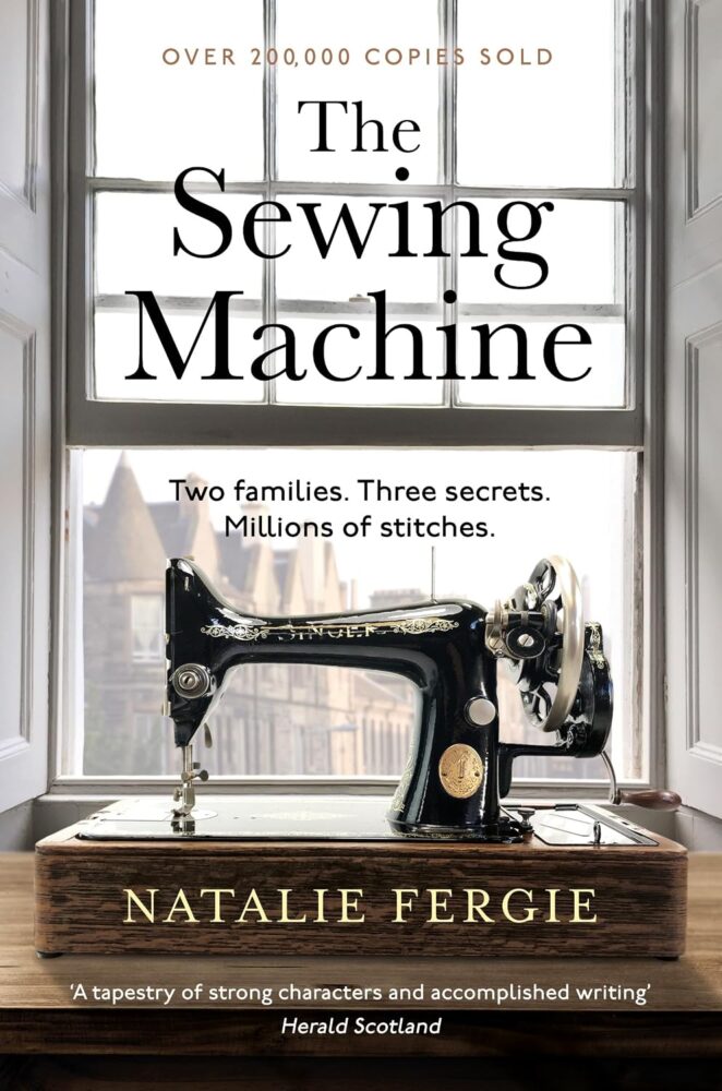 The sewing machine by natalie fergie, an old fashioned sewing machine in the window.